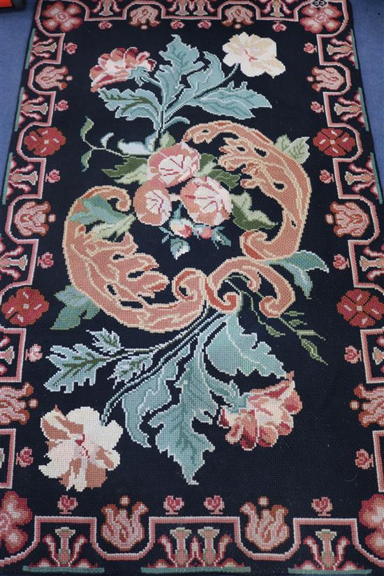 A Needleworked rug, 170cm by 105cm